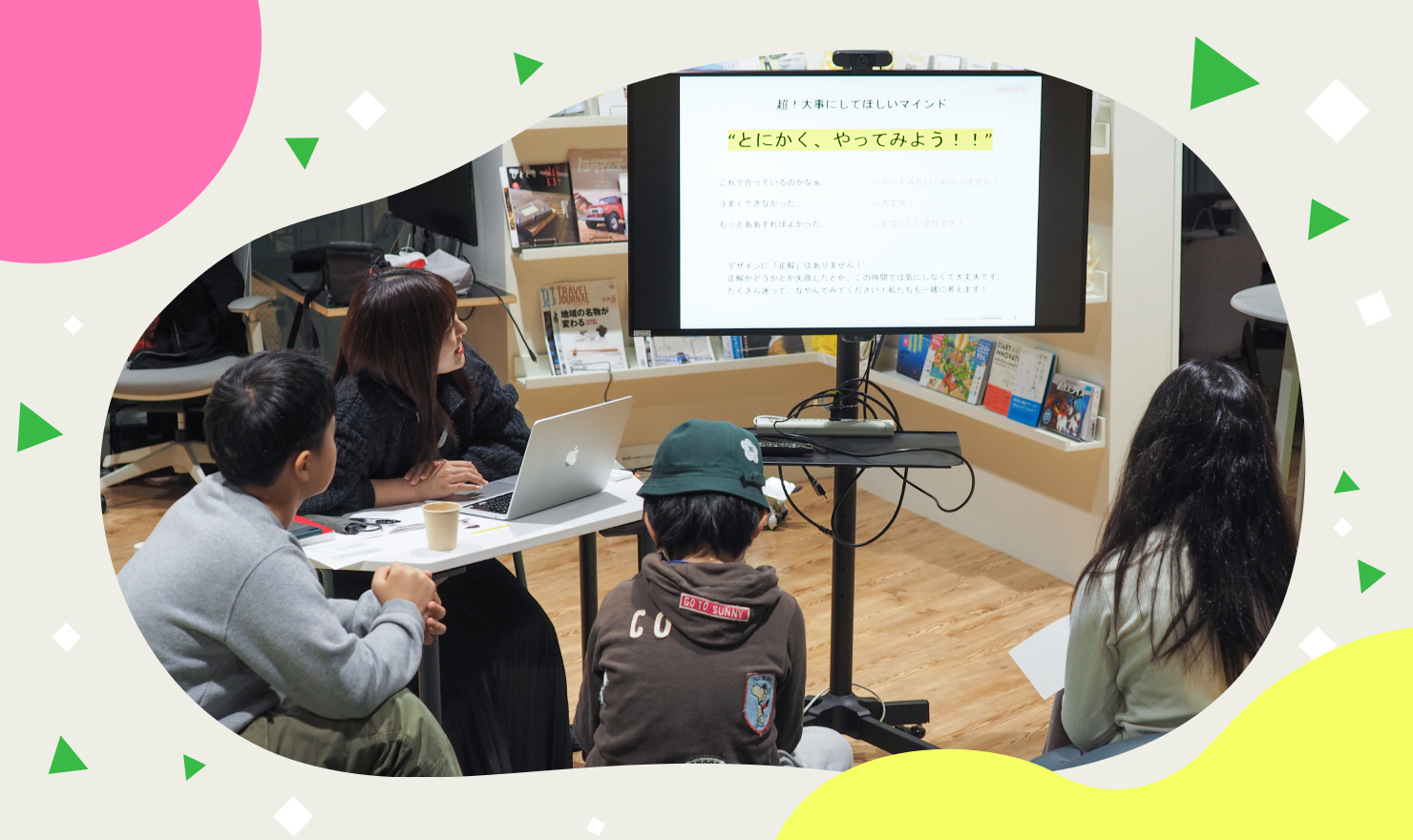 メインビジュアル。児童たちに課題を説明する様子。