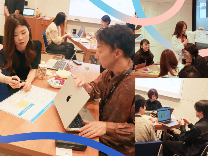 メインビジュアル。いくつかの小テーブルごとに議論している様子。