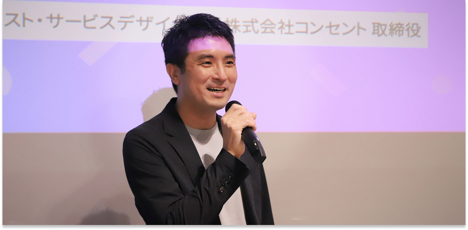 写真:笑顔でマイクを握り、会場に語りかける大﨑。